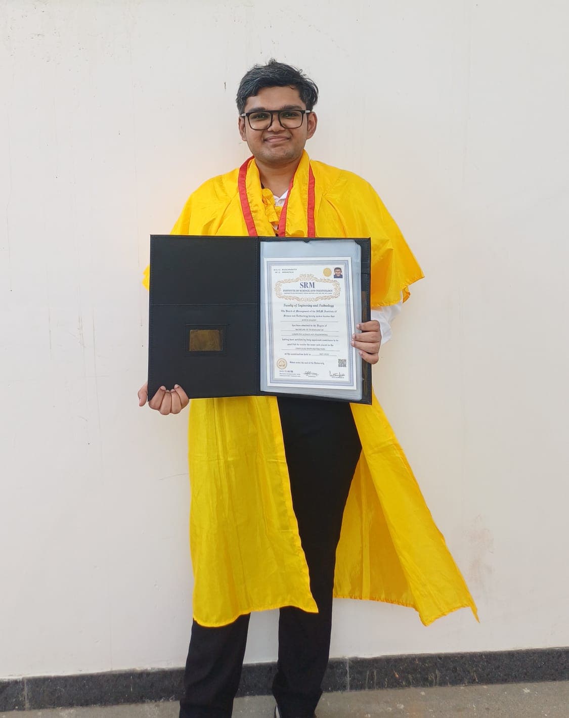 Aveeck Kumar Pandey holding his graduation certificate